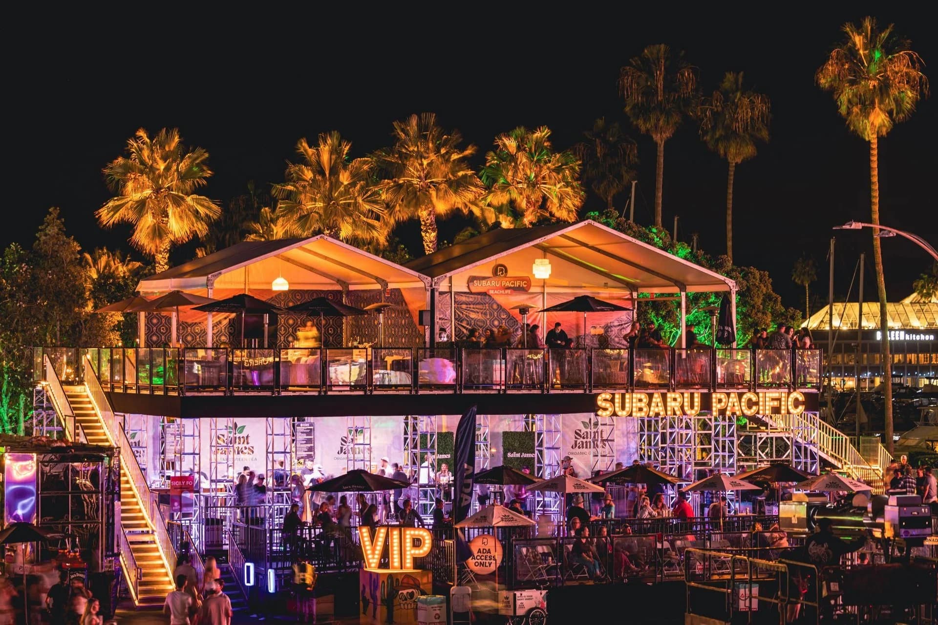 Furnished two-level festival hospitality environment illuminated at night
