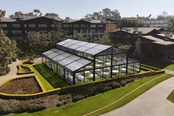 Black-frame Atrium Tent with clear walls and a raised central roof