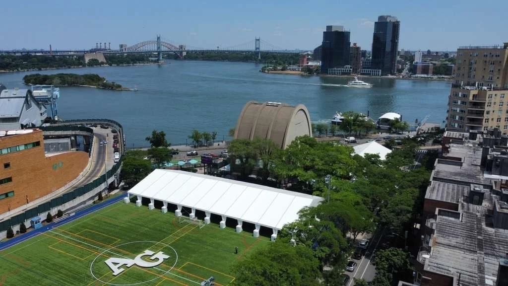 Large temporary event structure installed on an athletics field