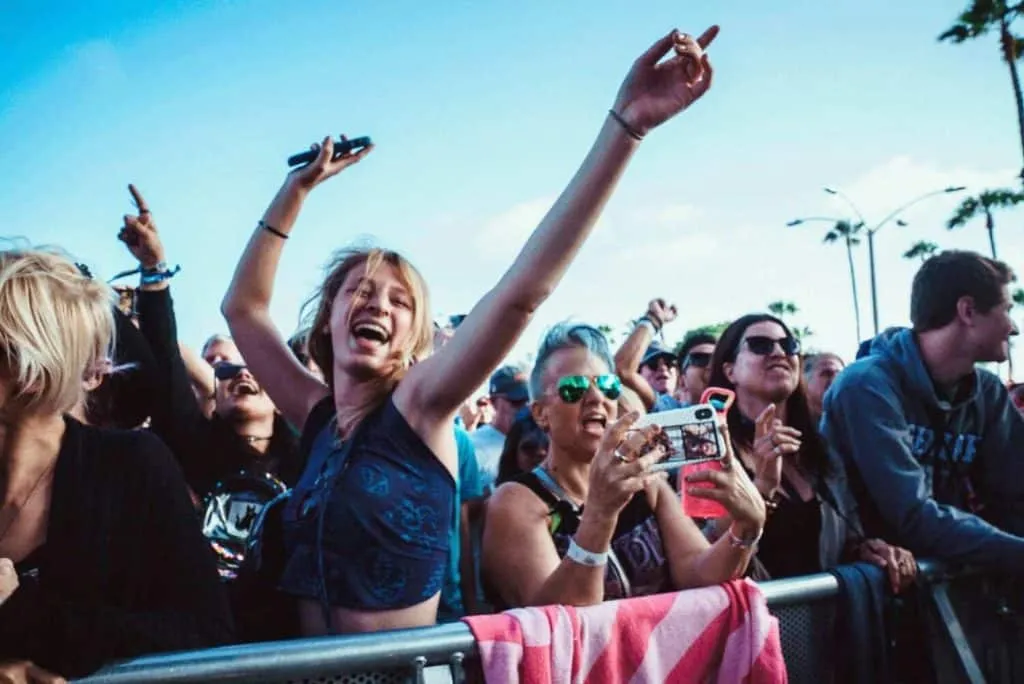 Girl enjoying festival music in a crowd.