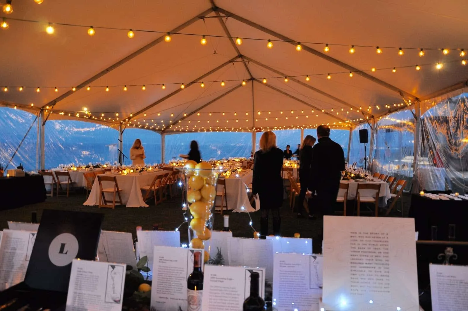 People inside a enclosed outside tent