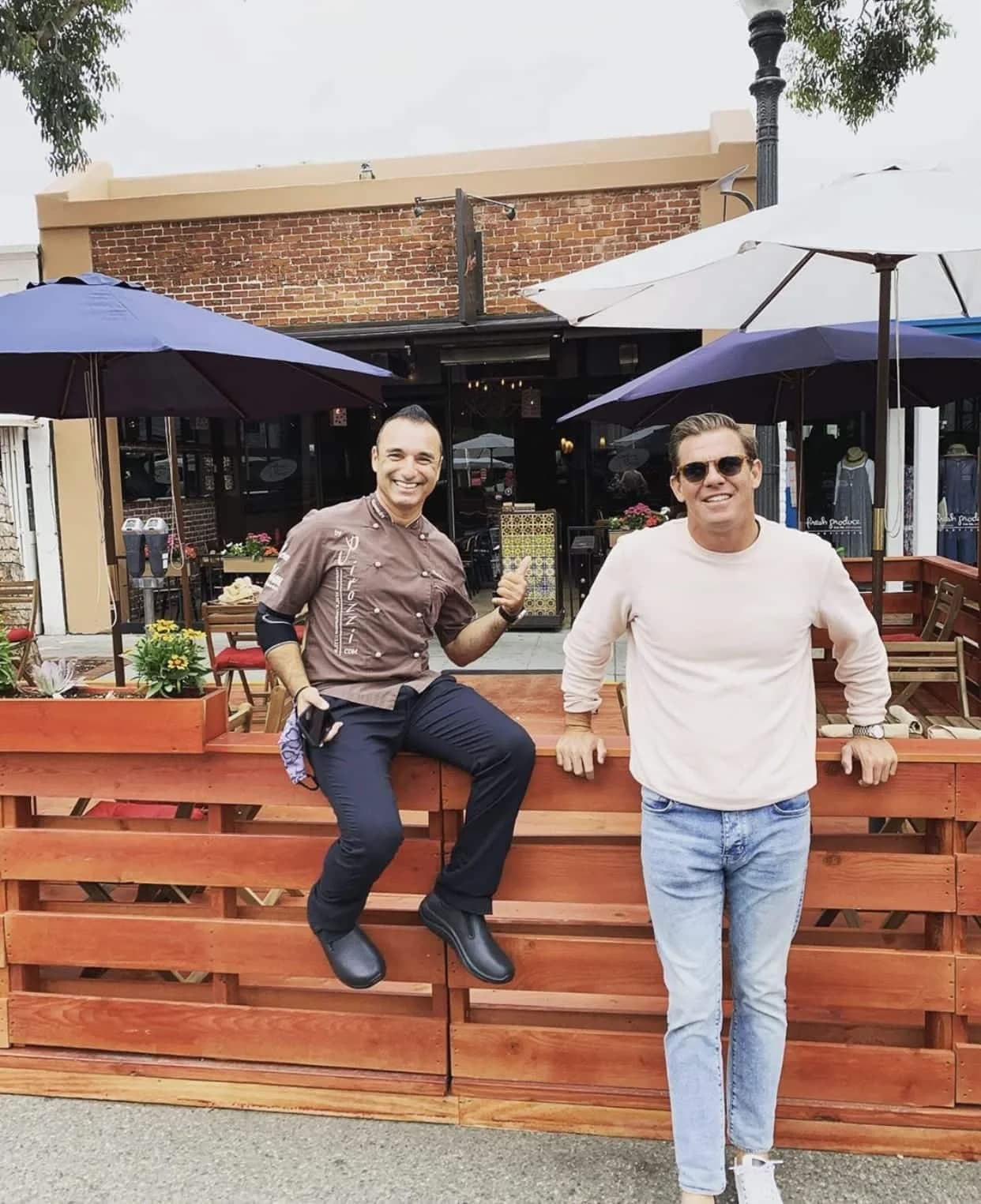 Ryan Choura with a restaurant owner beside an extended dining deck