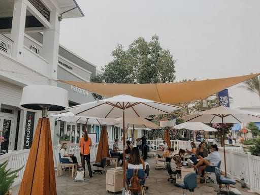 Outdoor patio with umbrellas for popup nail salon